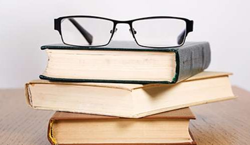 Glasses sitting on three books
