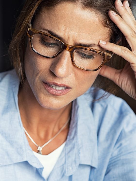 Woman wearing glasses with a frustrated look on her face